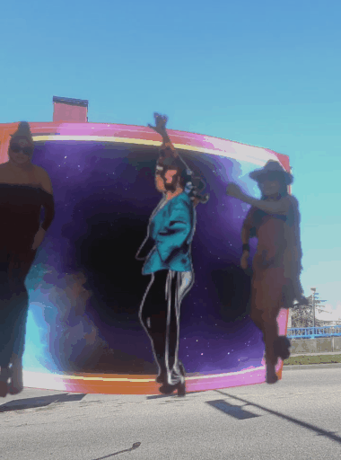 Costumed performers emerging from a glowing portal in the 3 Fates mural augmentation